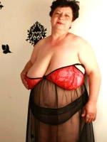Sweet curvy shaped babe in hot pink net top, black bra and sweet pink panties